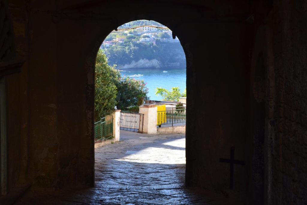 an archway with a cross in the middle of a street at Terra Murata Boutique b&b in Procida
