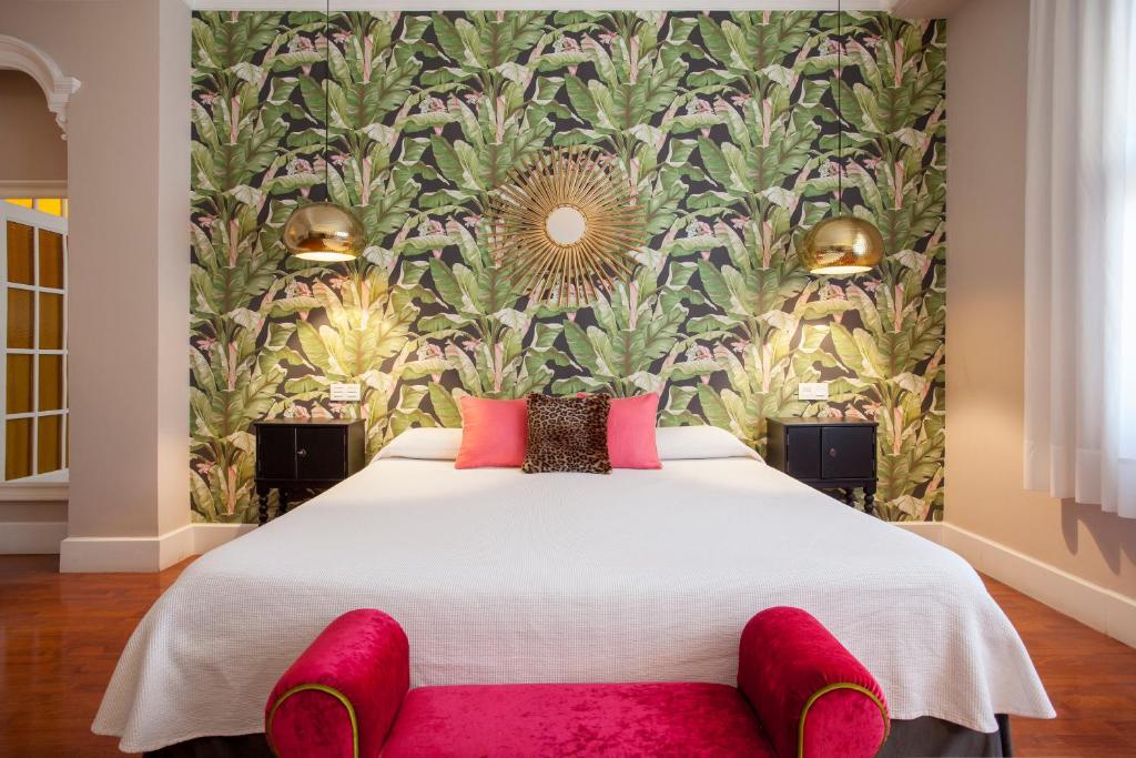 a bedroom with a large bed with a floral wallpaper at Hi Valencia Boutique in Valencia