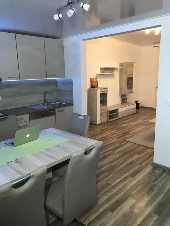 a kitchen with a table with a laptop on it at Ferienhaus Heil in Neustadt an der Weinstraße