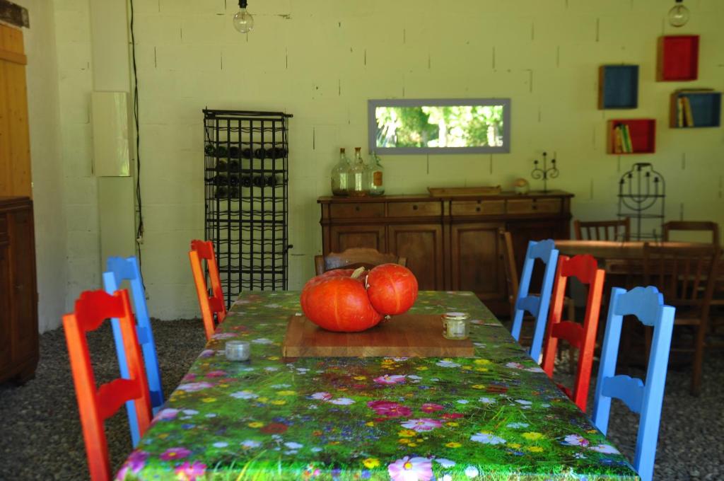 a table with two pumpkins sitting on top of it at La Grange in Le Plan
