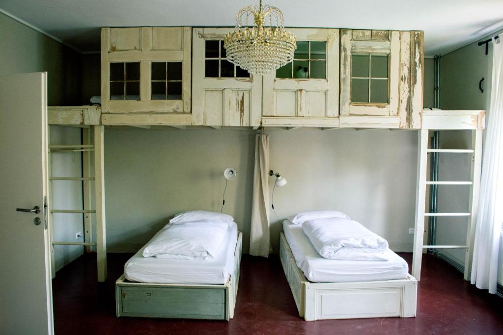 a bunk bed with two beds in a room at Hostel & Garten Eden in Leipzig