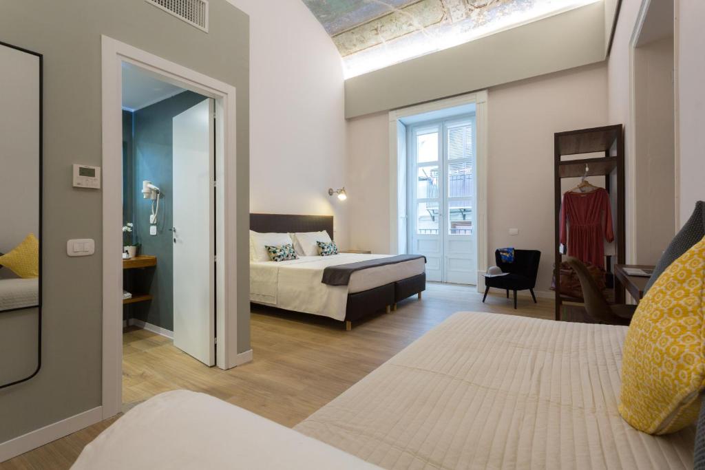 Una cama o camas en una habitación de Bellaroto Suite & SPA