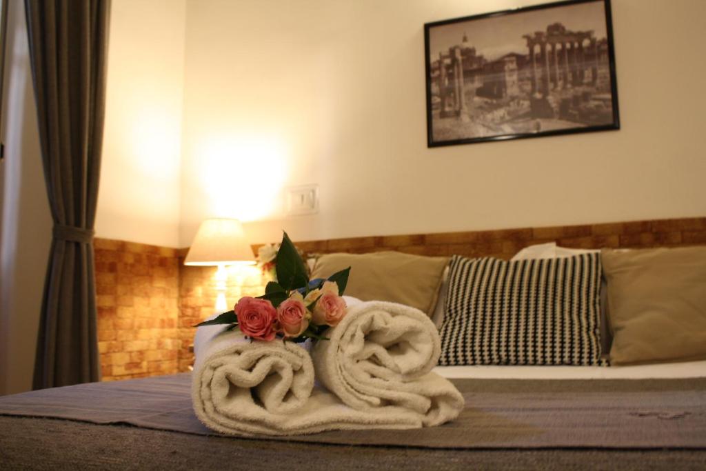 um quarto de hotel com uma cama com duas toalhas de cisne em Machiavelli Suites em Roma