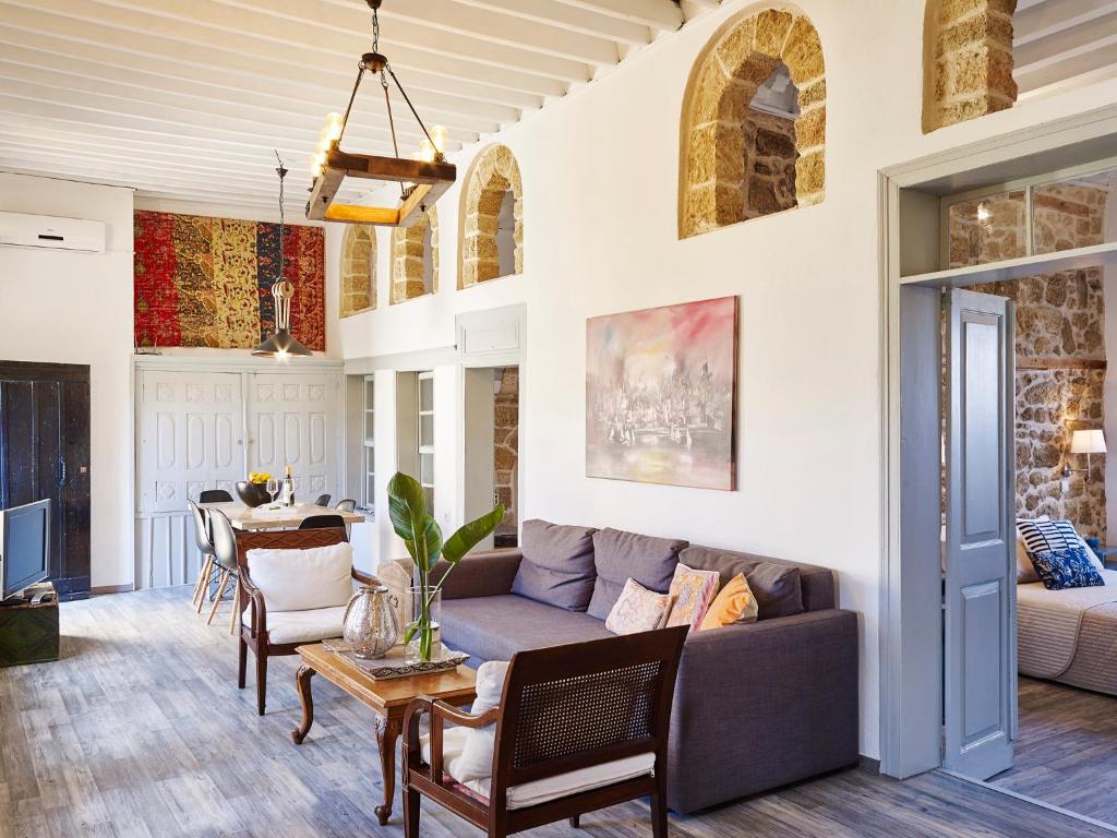 a living room with a couch and a table at The Old Town House in Rhodes Town