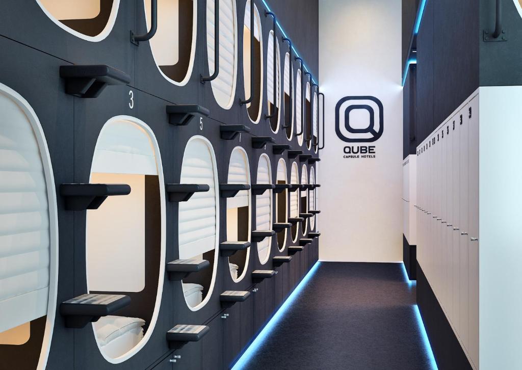 a hallway with rows of mirrors on the wall at Qube Capsule Hotel in Moscow