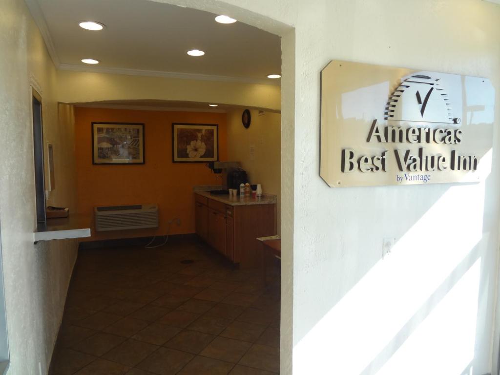 a hallway with a best value line sign on a wall at Americas Best Value Inn - Goldsboro in Goldsboro