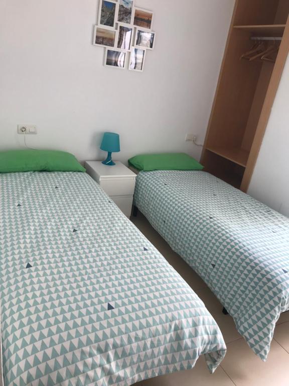 A bed or beds in a room at Ílios Apartamentos