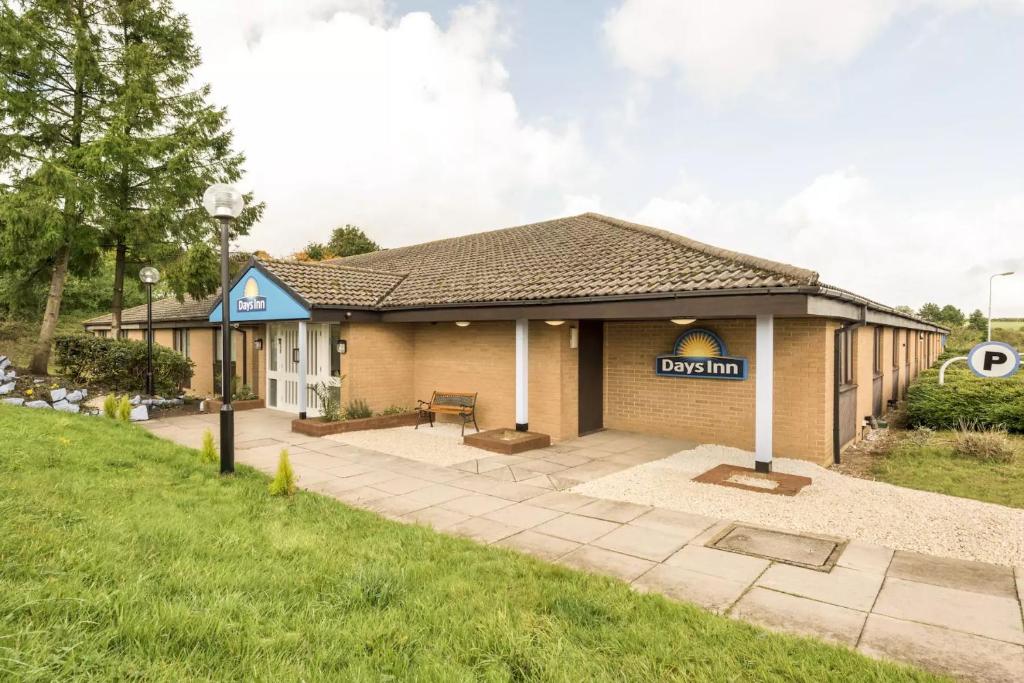 un bâtiment avec un panneau indiquant doyen dans l'établissement Days Inn Sutton Scotney North, à Sutton Scotney