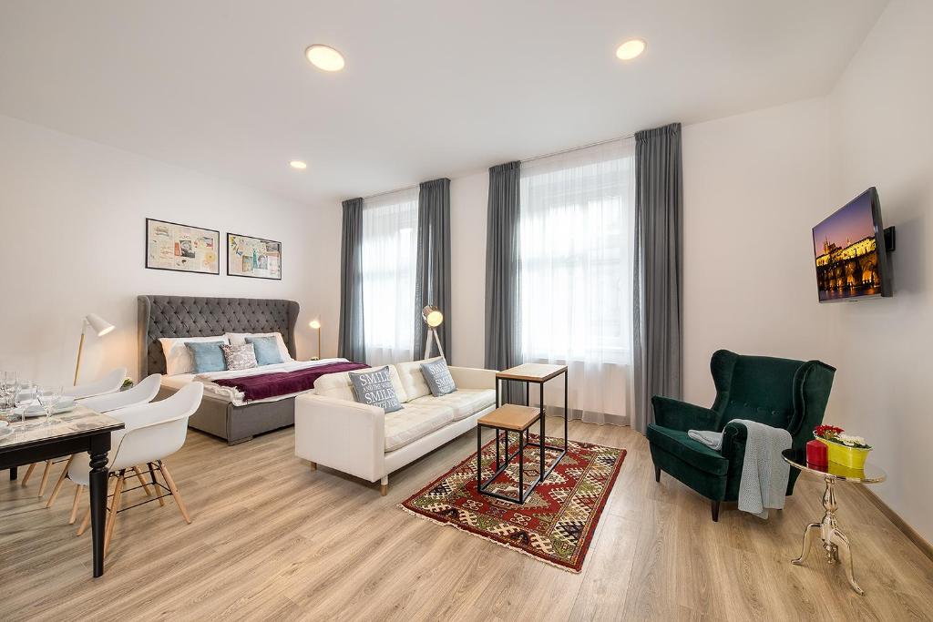 a living room with a couch and a table at Luxurious Apartments Karlin in Prague