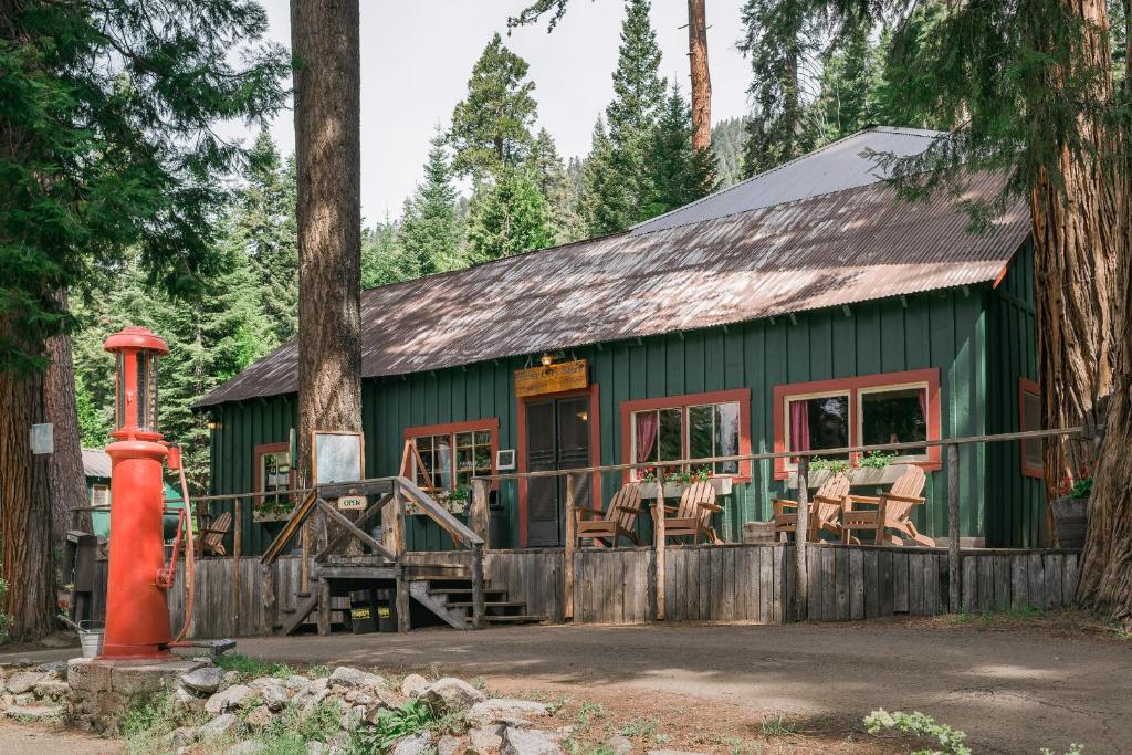 a green building with chairs in front of it at Silver City Mountain Resort in Sequoia National Park