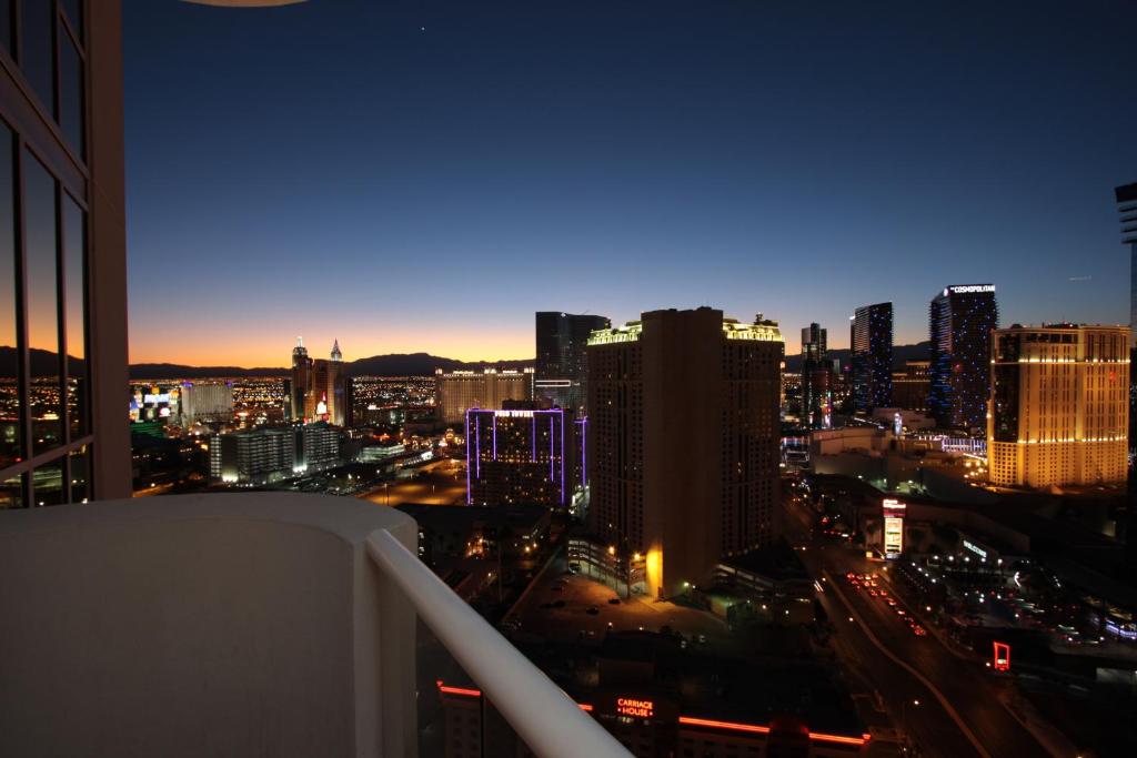 a city street at night with tall buildings at Luxury Suites International at The Signature in Las Vegas