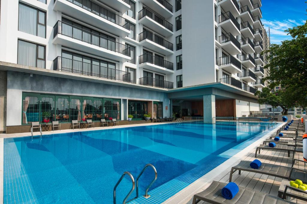 an image of a swimming pool in front of a building at Somerset West Point Hanoi in Hanoi