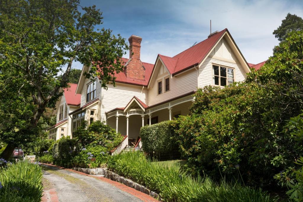 a large white house with a red roof at Franklin Manor in Strahan