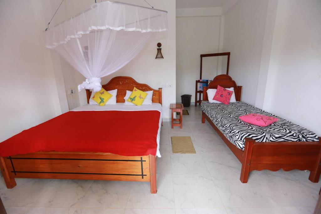 Postel nebo postele na pokoji v ubytování Ella Cloud Castle Homestay