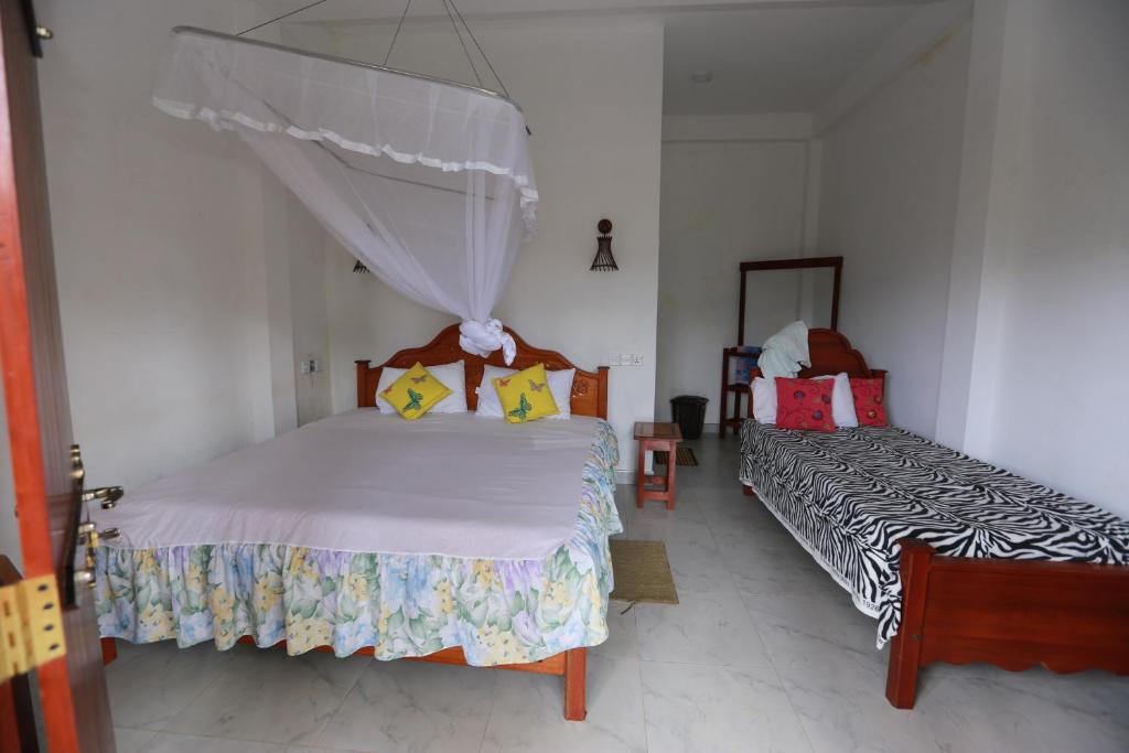 Postel nebo postele na pokoji v ubytování Ella Cloud Castle Homestay