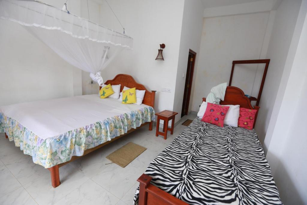 Postel nebo postele na pokoji v ubytování Ella Cloud Castle Homestay