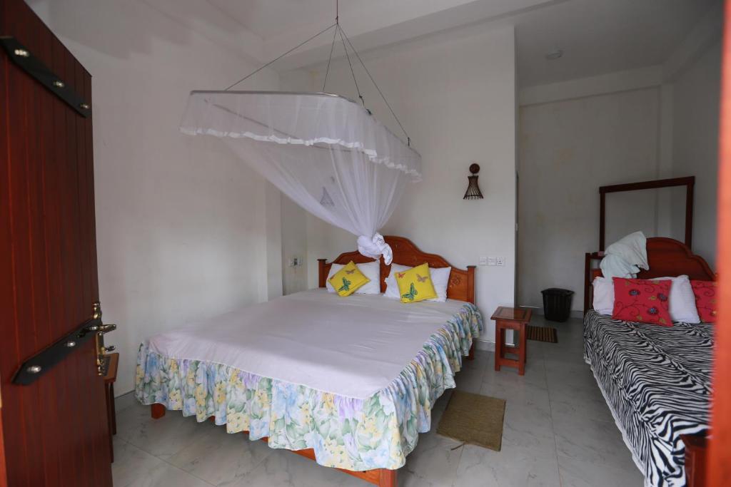 Postel nebo postele na pokoji v ubytování Ella Cloud Castle Homestay