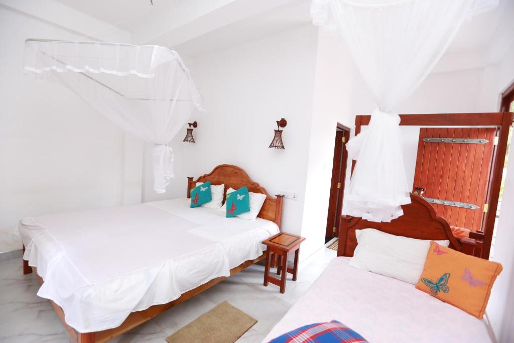 Postel nebo postele na pokoji v ubytování Ella Cloud Castle Homestay