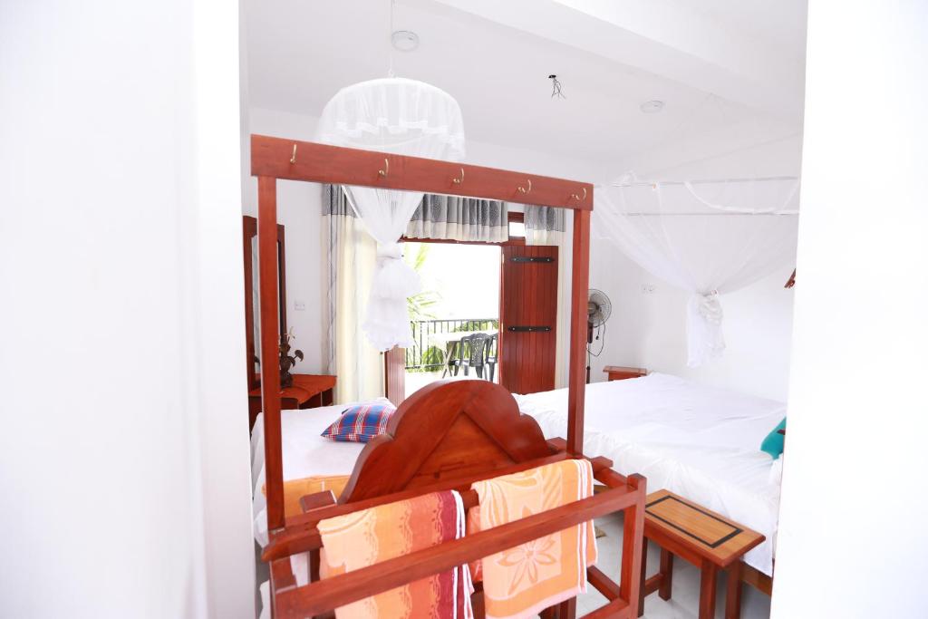 Postel nebo postele na pokoji v ubytování Ella Cloud Castle Homestay