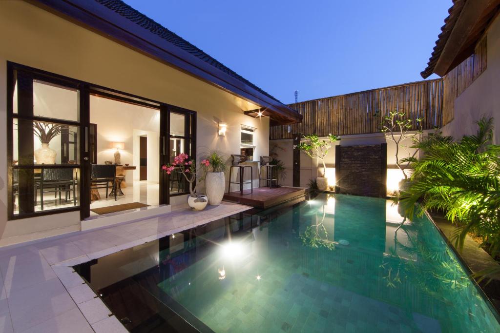 a swimming pool in the backyard of a house at Amalika Private Pool Villa Central to Everything in Gili Trawangan