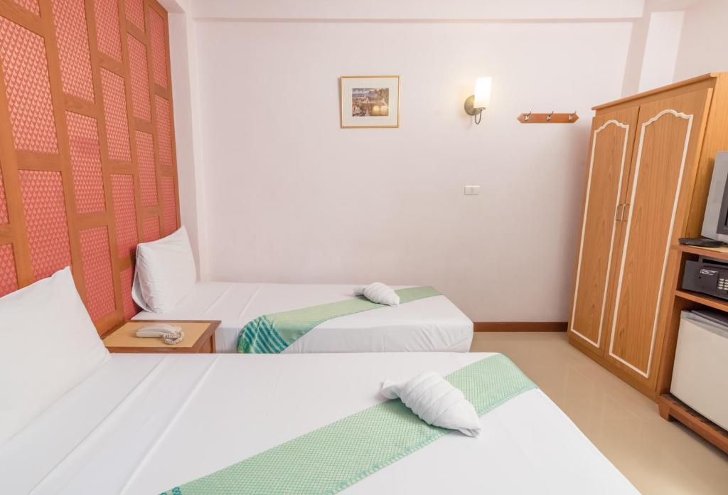 Postel nebo postele na pokoji v ubytování New Siam III Guest House