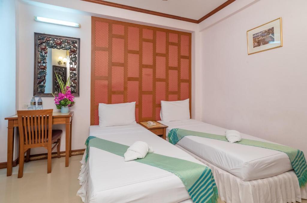 Postel nebo postele na pokoji v ubytování New Siam III Guest House