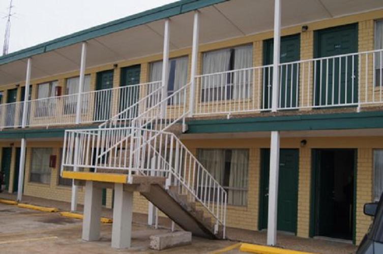 a building with a staircase on the side of it at Budget Inn in Waco