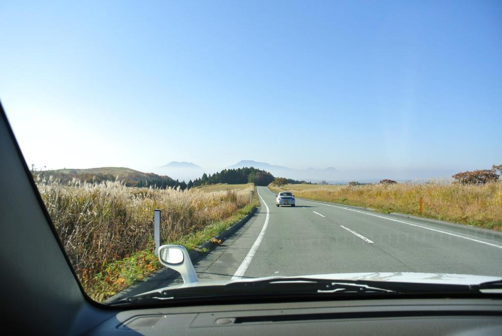 a car driving down a road with a car at Polan no Fue in Minamioguni