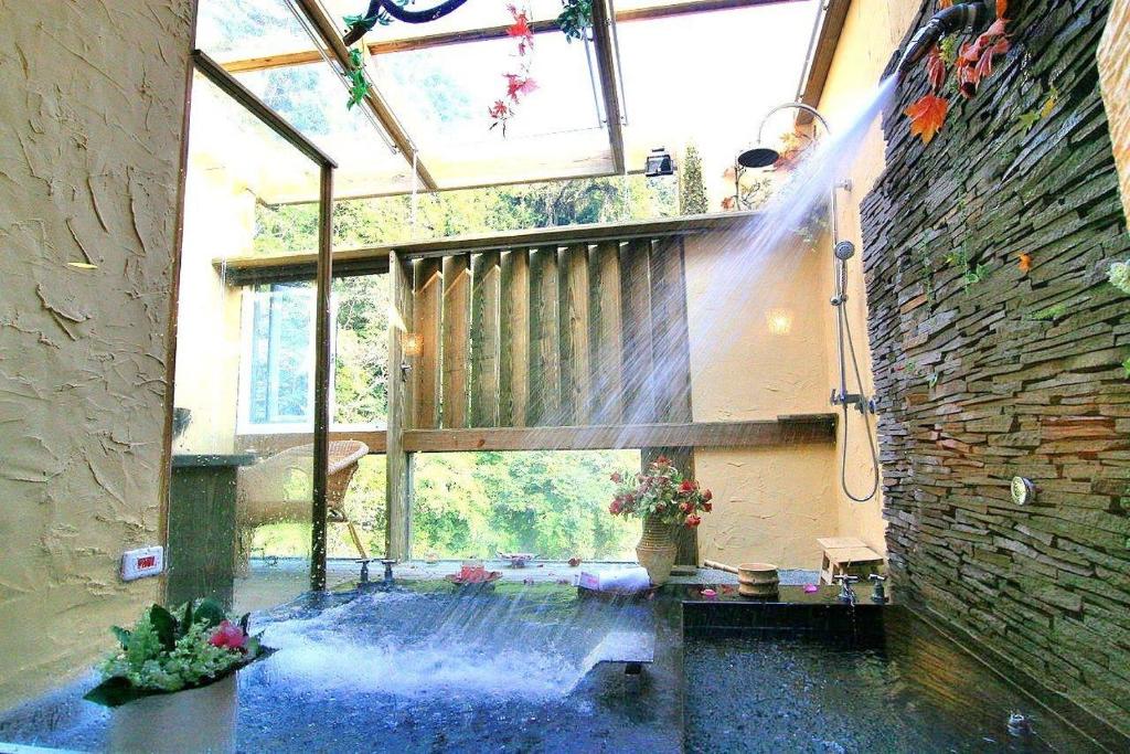a large room with a large window and a room with a water fountain at 51 Spring in Wulai