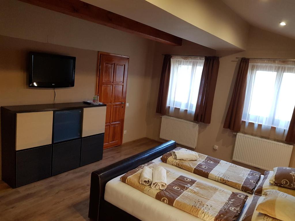 Postel nebo postele na pokoji v ubytování Centrum Vendégház