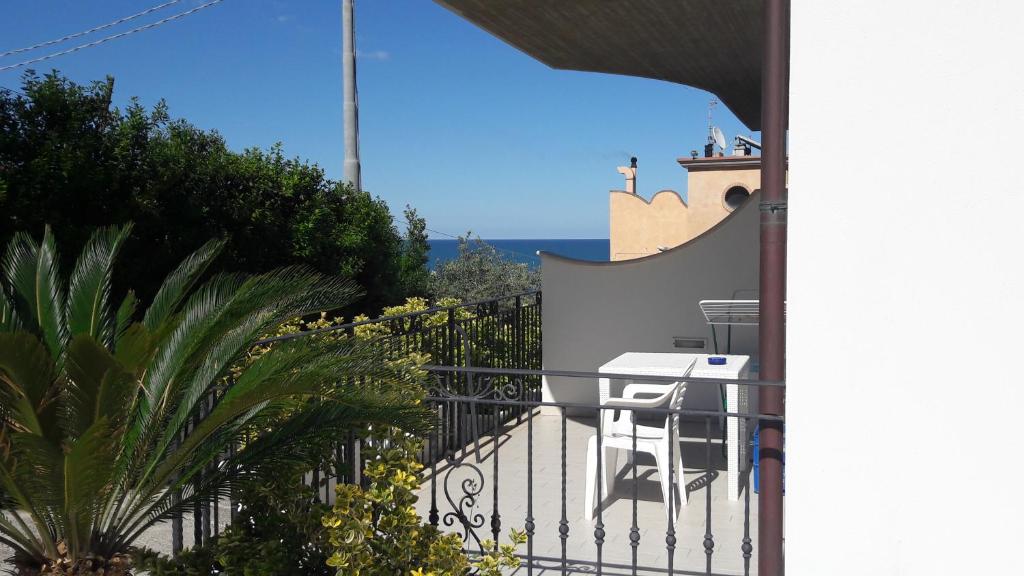 a balcony of a house with a table and chairs at Casa Orti in Grottammare