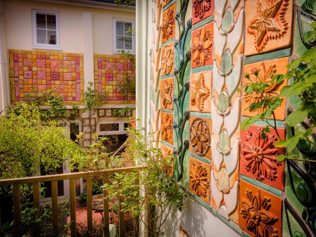 a house with a wall covered in colorful tiles at The Ceramic House in Brighton & Hove