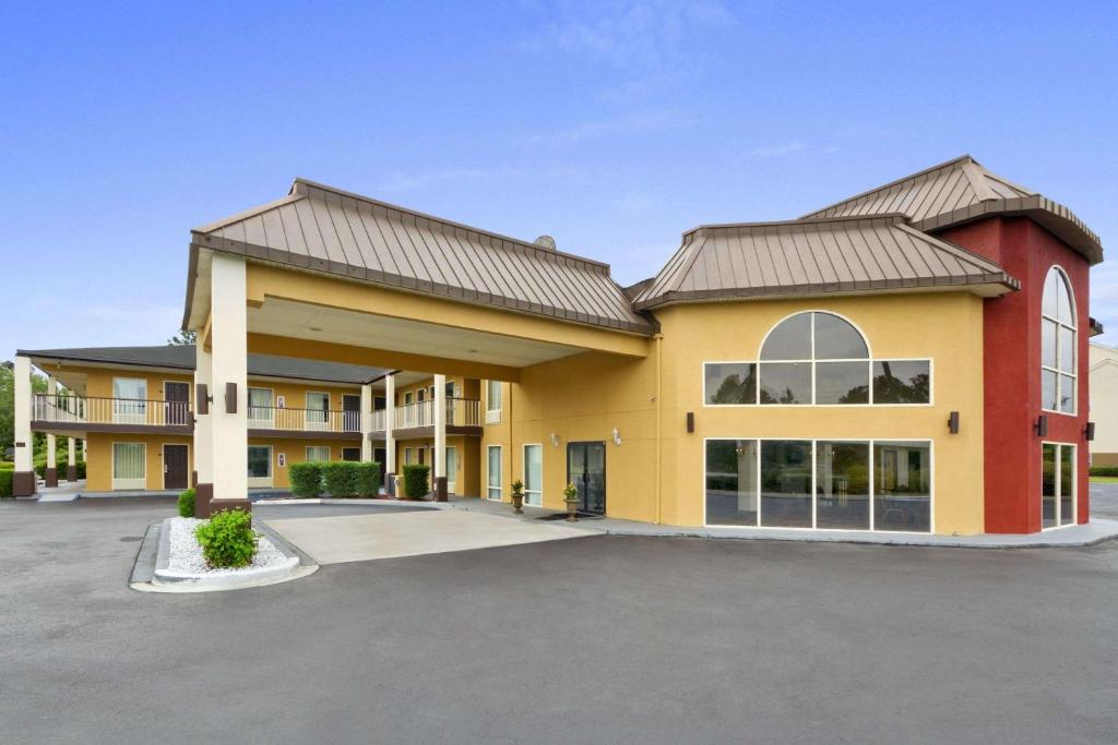 a large building with a parking lot at Baymont by Wyndham Santee in Santee
