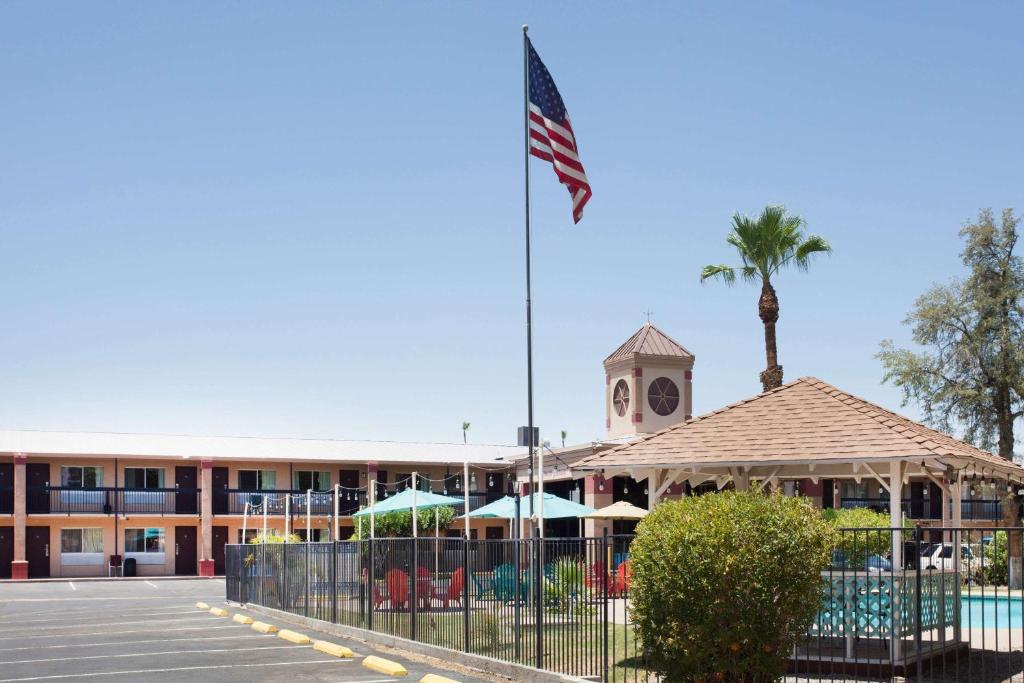 un hotel con una bandera americana delante de él en Howard Johnson by Wyndham Yuma en Yuma