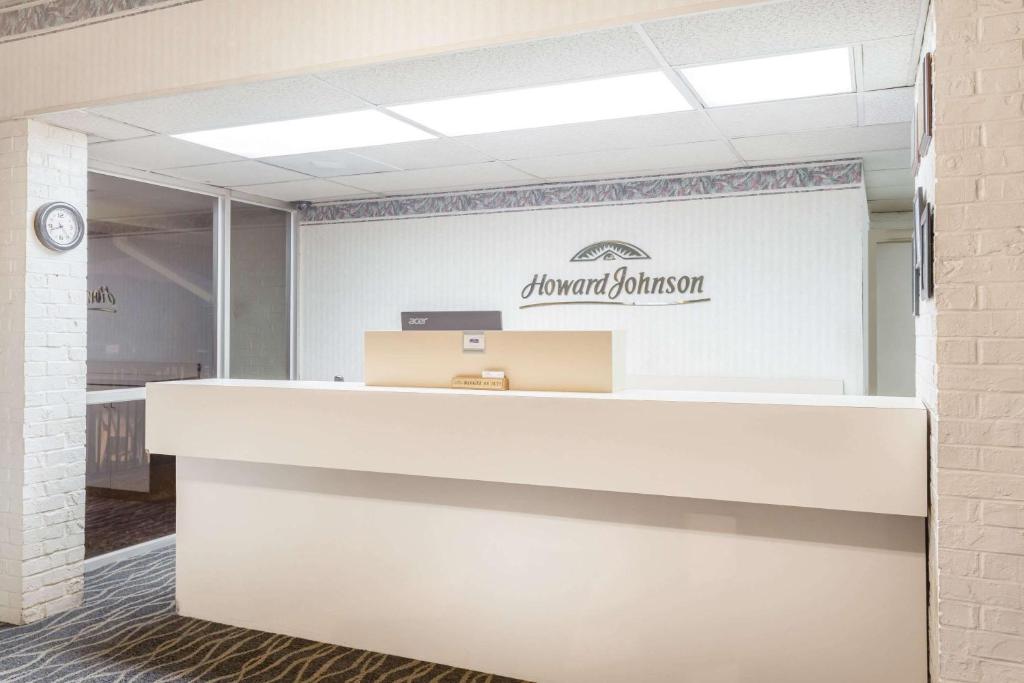 an office with a desk and a sign on the wall at Howard Johnson by Wyndham Commerce GA in Commerce