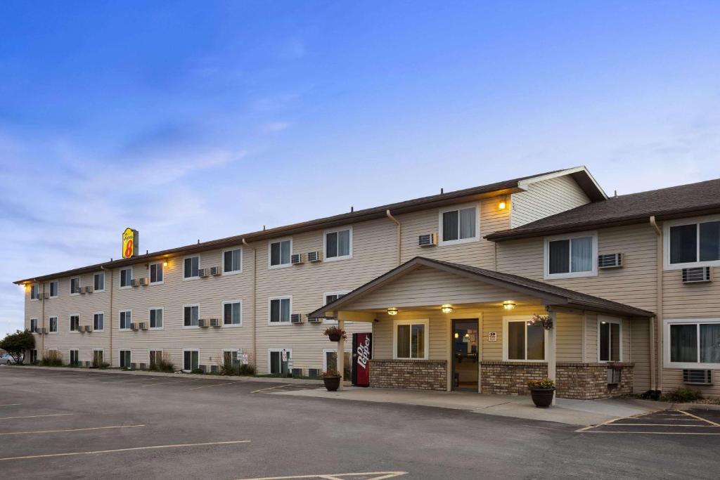 a hotel with a parking lot in front of it at Super 8 by Wyndham Council Bluffs IA Omaha NE Area in Council Bluffs