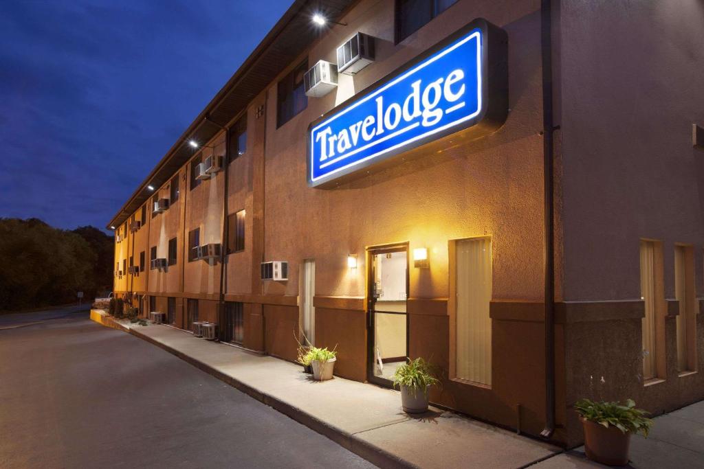 a hotel building with a sign on the side of it at Travelodge by Wyndham La Porte/Michigan City Area in LaPorte