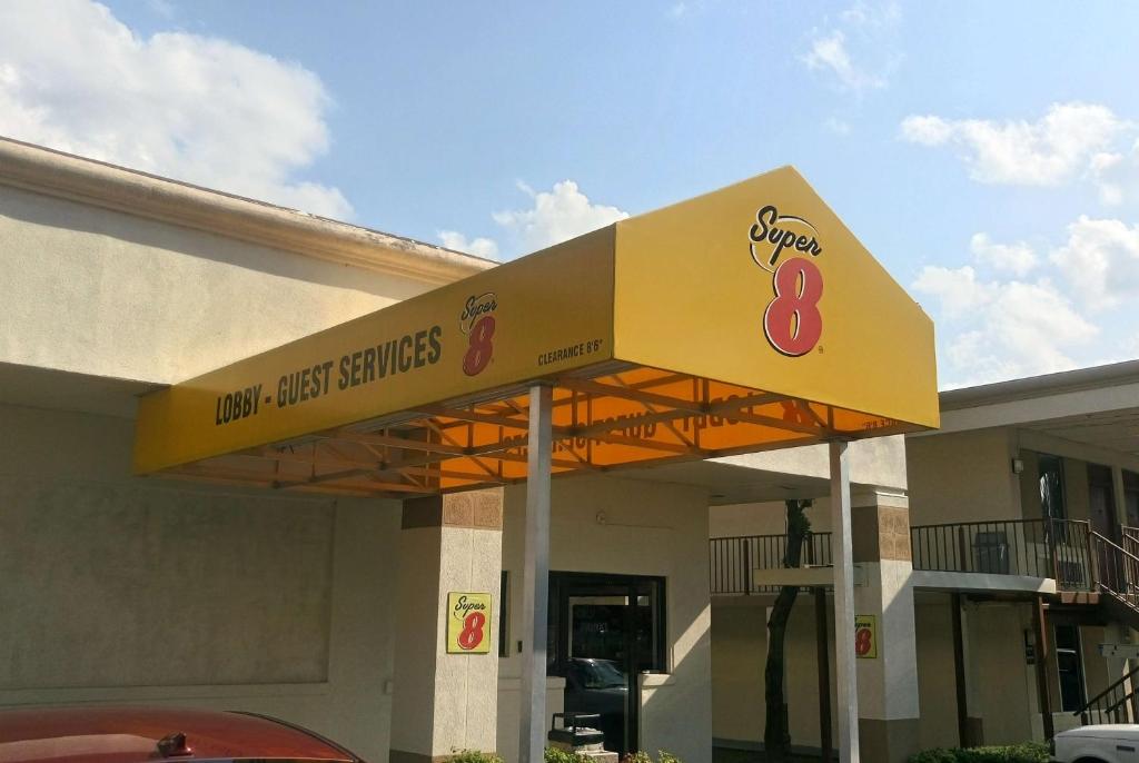 a gas station with a sign that reads new best service at Super 8 by Wyndham Dover in Dover