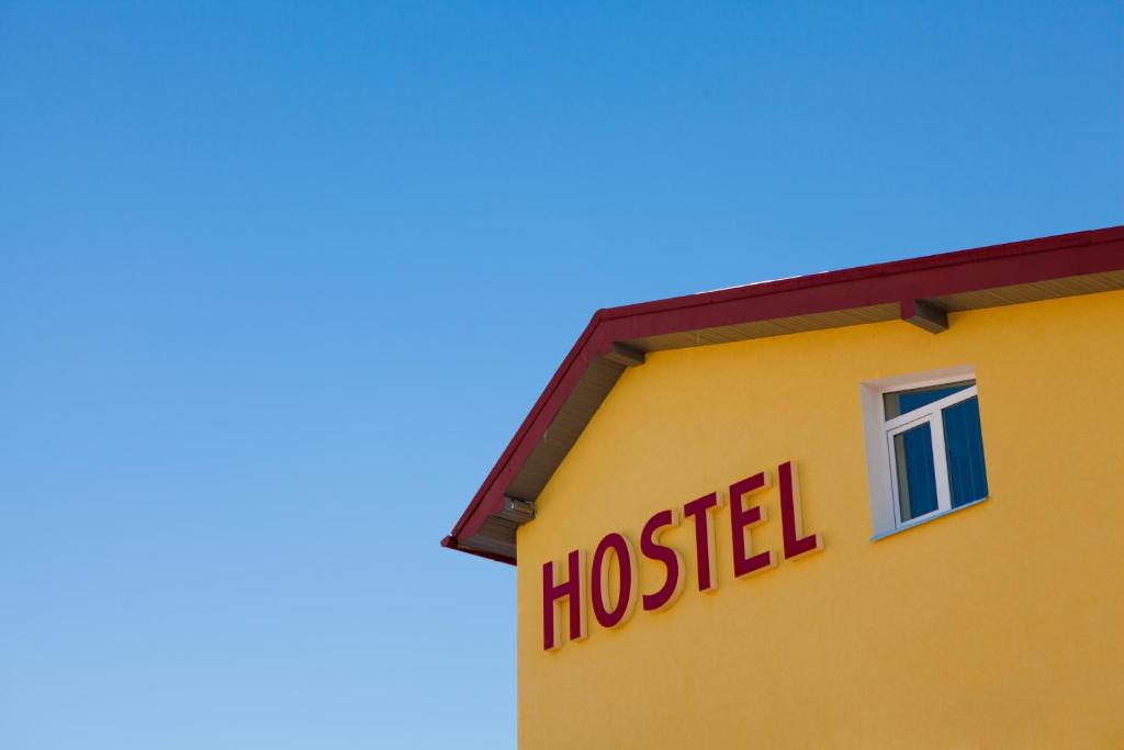 a yellow building with a hospital sign on it at Pilgrim Hostel in Ivano-Frankivsk