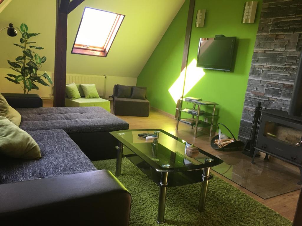 a living room with a couch and a fireplace at Apartman Adele in Rumburk