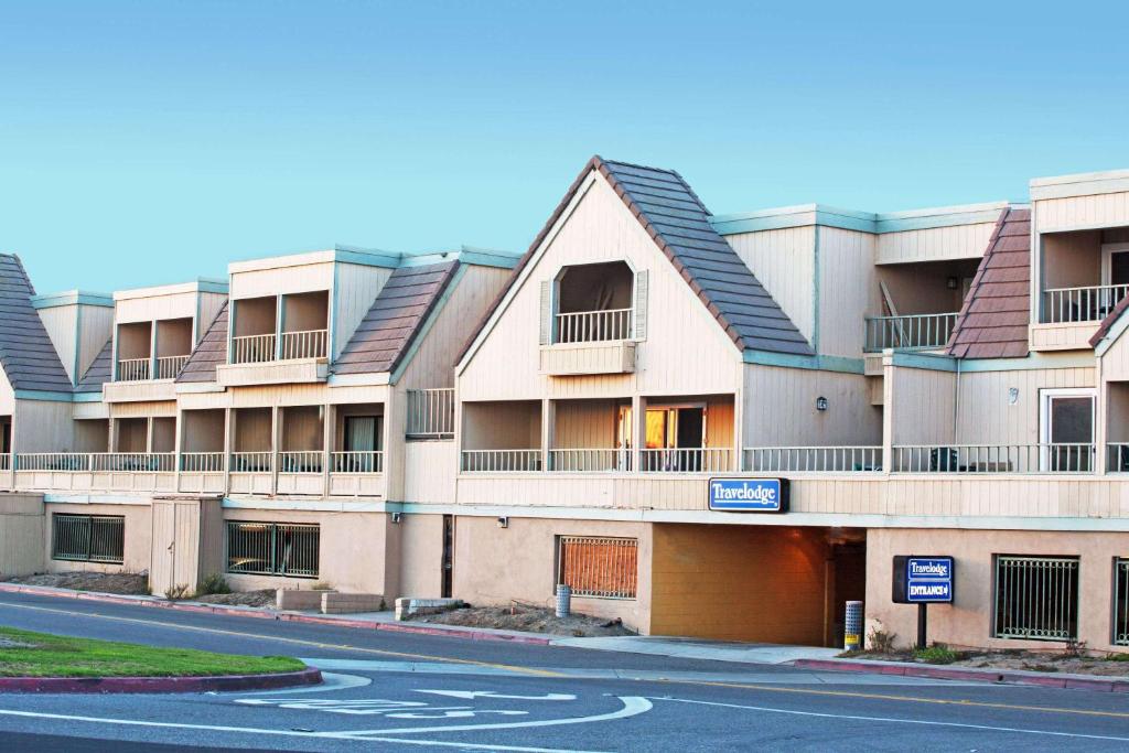 an apartment building with a road in front of it at Travelodge by Wyndham Ocean Front in Sunset Beach