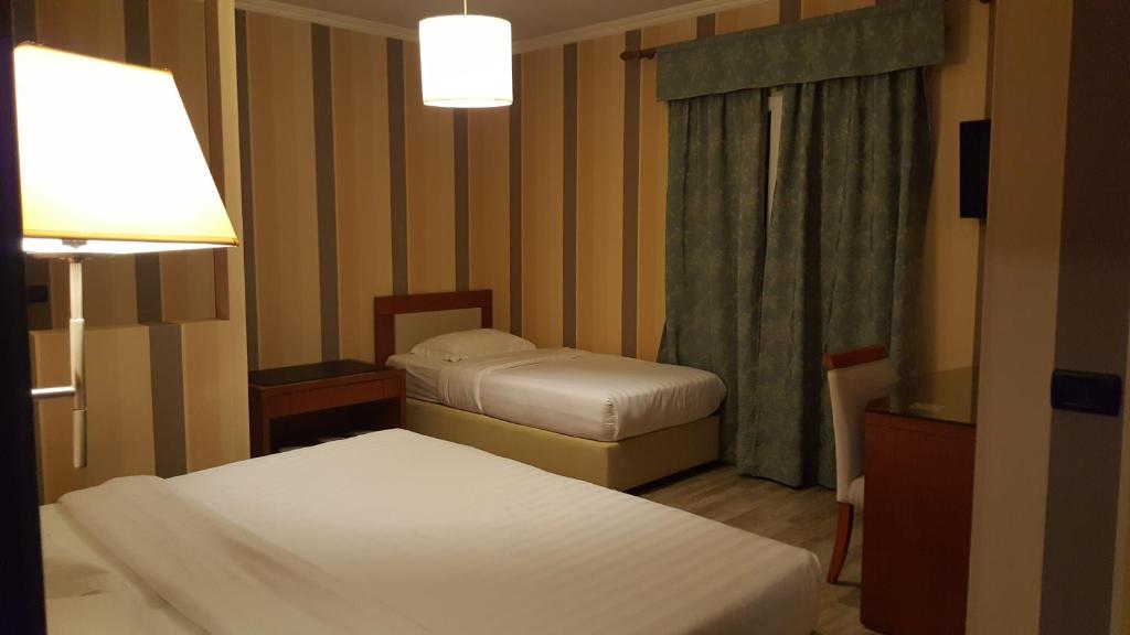 Postel nebo postele na pokoji v ubytování Bel Conti Hotel