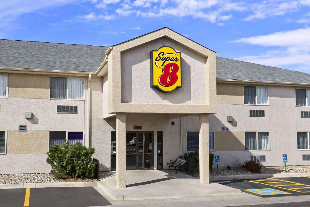 a building with a sign for a fast food restaurant at Super 8 by Wyndham Colorado Springs Airport in Colorado Springs