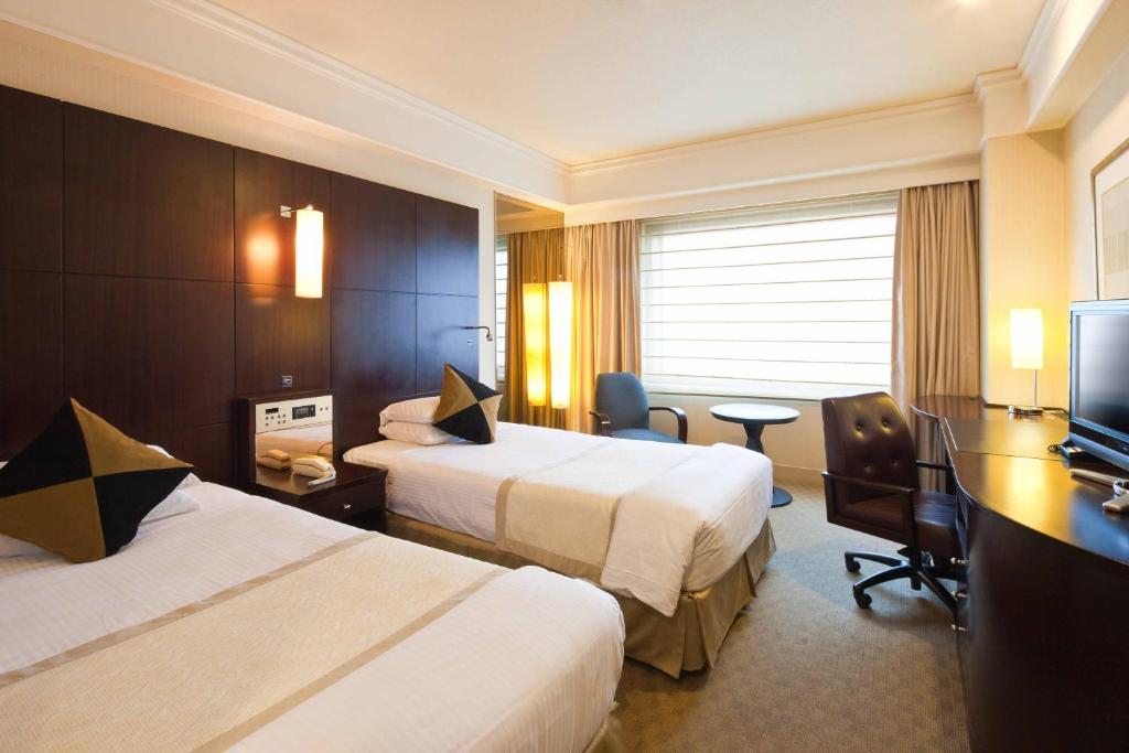 Postel nebo postele na pokoji v ubytování Royal Park Hotel