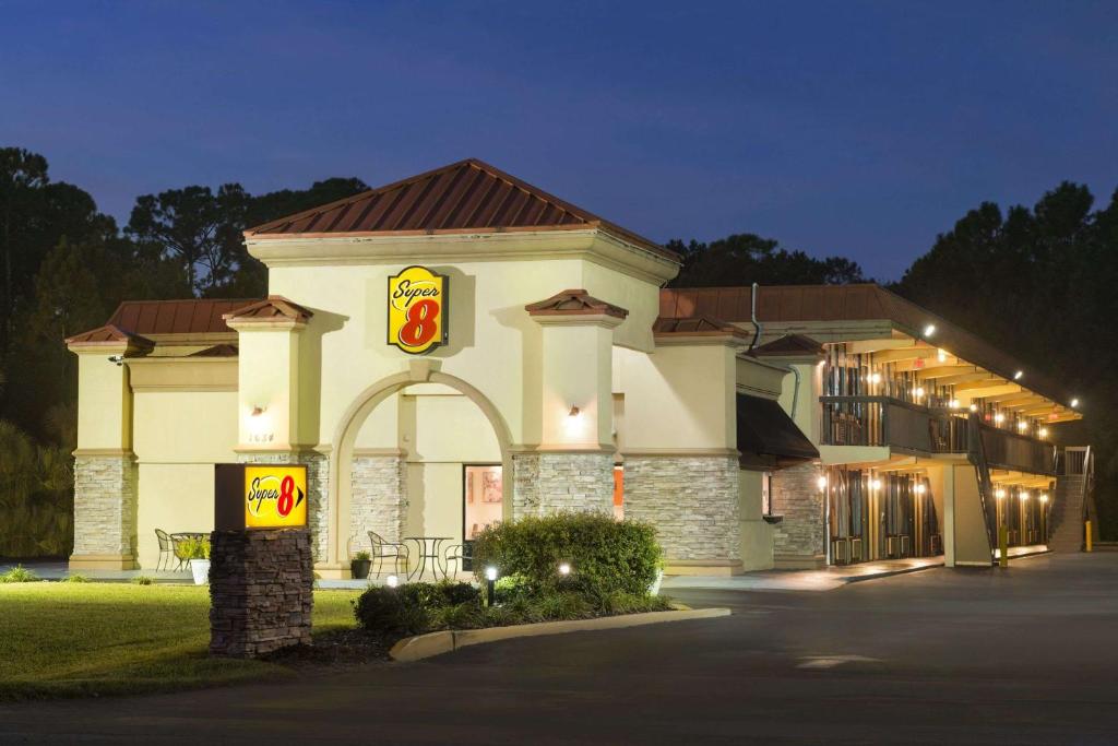 a hotel building with a sign in front of it at Super 8 by Wyndham Ormond Beach in Ormond Beach