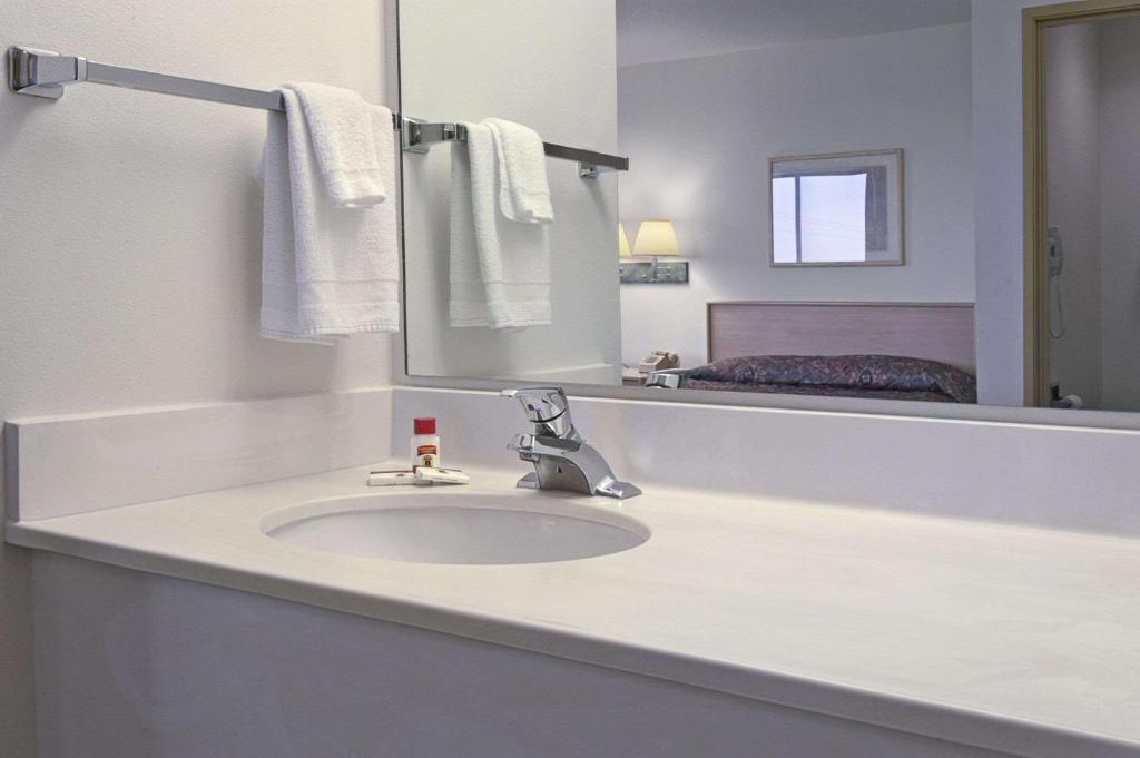 a bathroom with a sink and a mirror at Arch Canyon Inn in Blanding