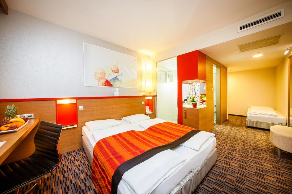 A bed or beds in a room at Royal Park Boutique Hotel