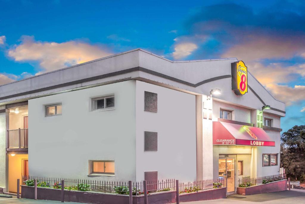 a white building with a fast food restaurant at Super 8 by Wyndham North Bergen NJ/NYC Area in North Bergen