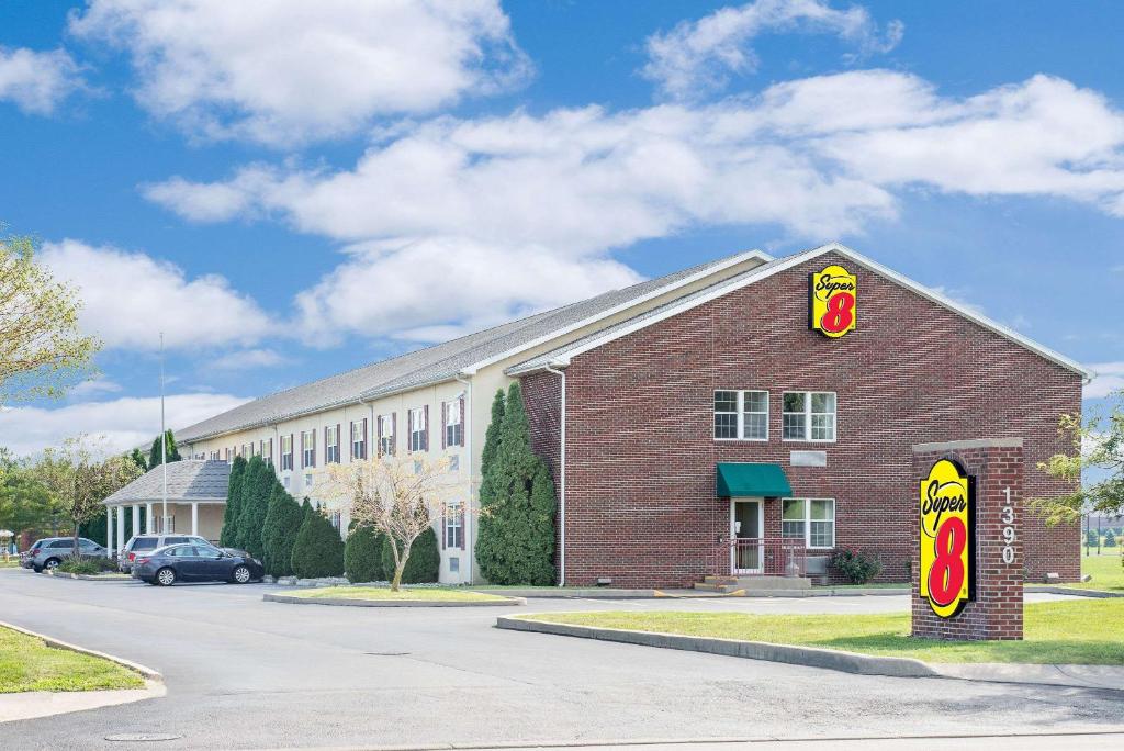 a fast food restaurant with a sign on the side of a building at Super 8 by Wyndham Maumee Perrysburg Toledo Area in Maumee