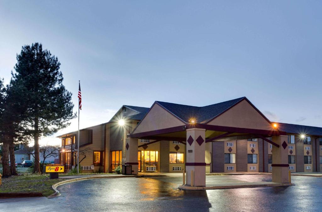 a hotel building with a flag in front of it at Super 8 by Wyndham Denver Stapleton in Denver